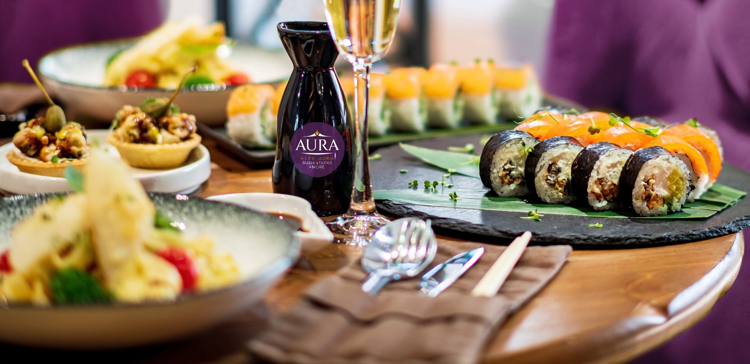 A set table at the Aura restaurant in the Schlosshotel Mondsee, with maki, tapas and soy sauce.